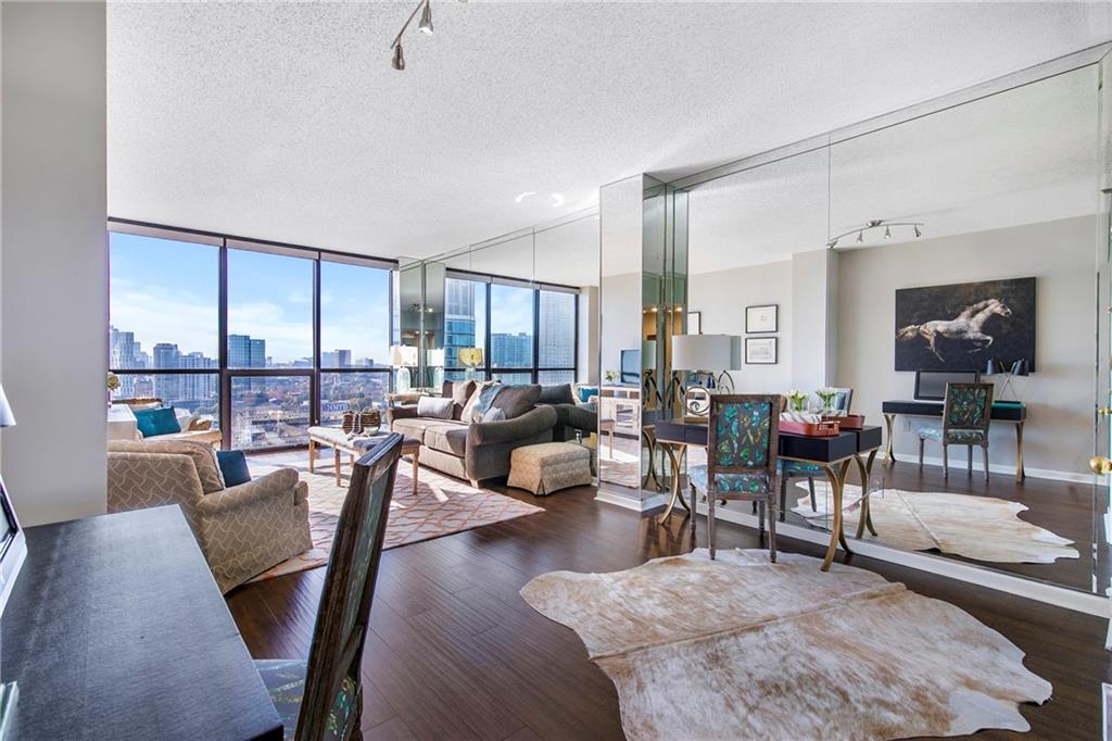 1280 West Peachtree Street Northwest, Unit 3806 Atlanta, GA 30309 - Photo 2 of 35 a living room with furniture kitchen view and a large window