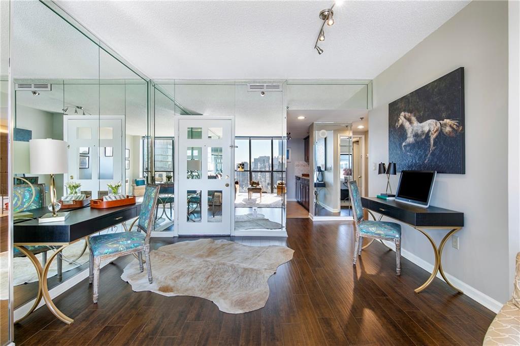 1280 West Peachtree Street Northwest, Unit 3806 Atlanta, GA 30309 - Photo 3 of 35 a living room with fireplace furniture and a wooden floor