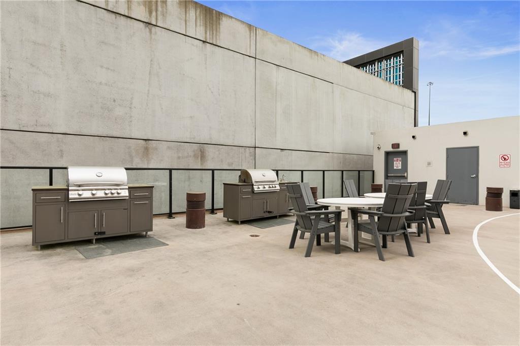 1280 West Peachtree Street Northwest, Unit 3806 Atlanta, GA 30309 - Photo 31 of 35 a view of a patio with table and chairs