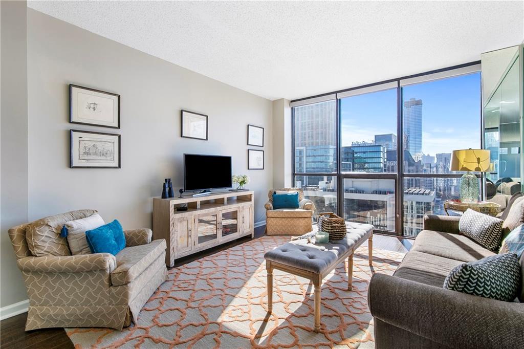 1280 West Peachtree Street Northwest, Unit 3806 Atlanta, GA 30309 - Photo 5 of 35 a living room with furniture and a flat screen tv