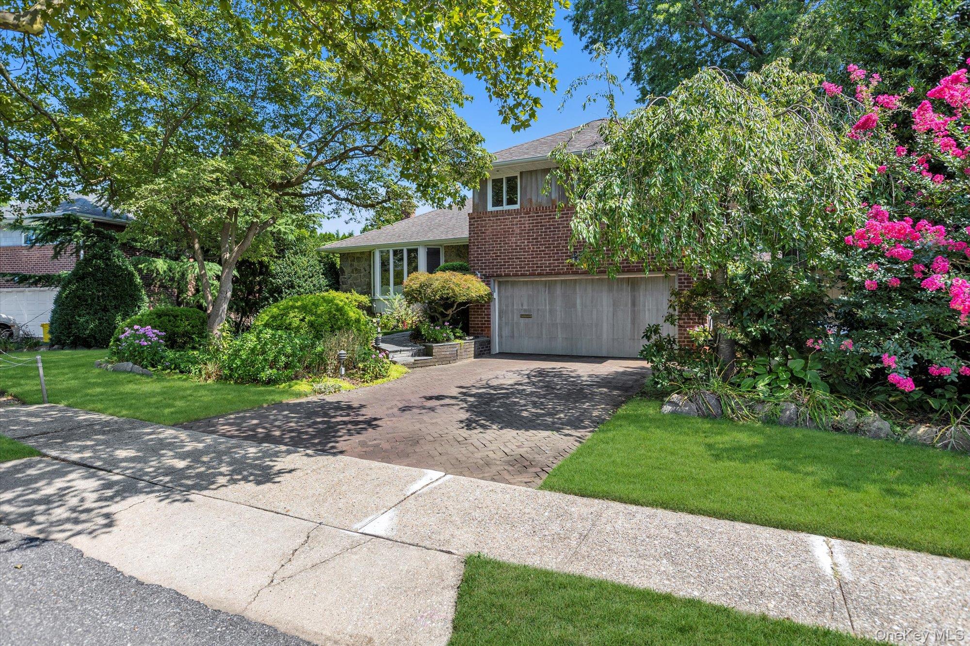 19 Clearland Road Syosset, NY 11791 - Photo 2 of 22 Tri-level home with brick siding, driveway, a garage, a front yard, and a shingled roof