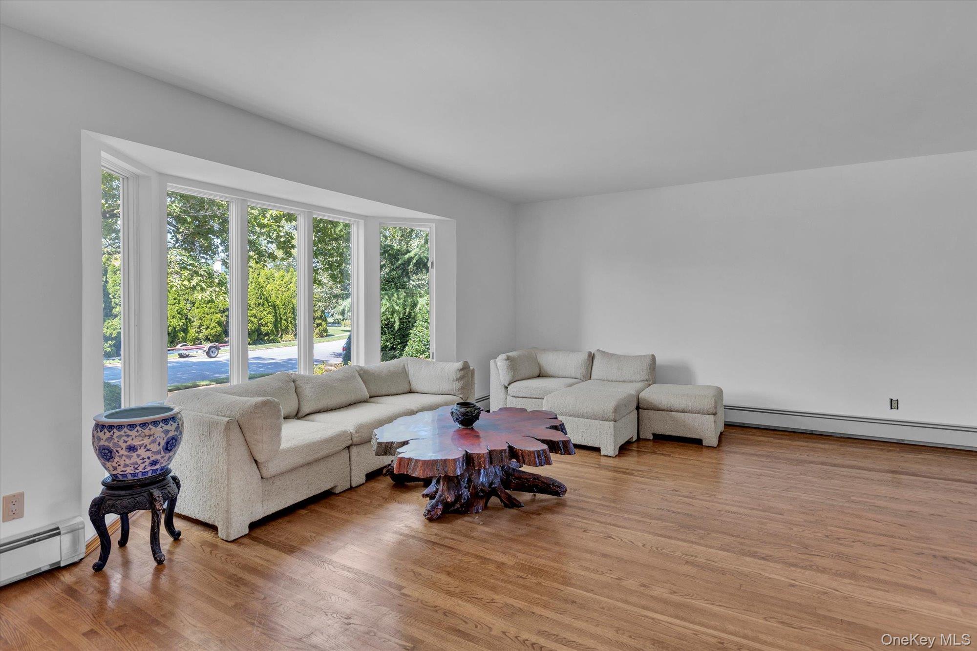 19 Clearland Road Syosset, NY 11791 - Photo 6 of 22 Living area featuring light wood-type flooring and baseboard heating
