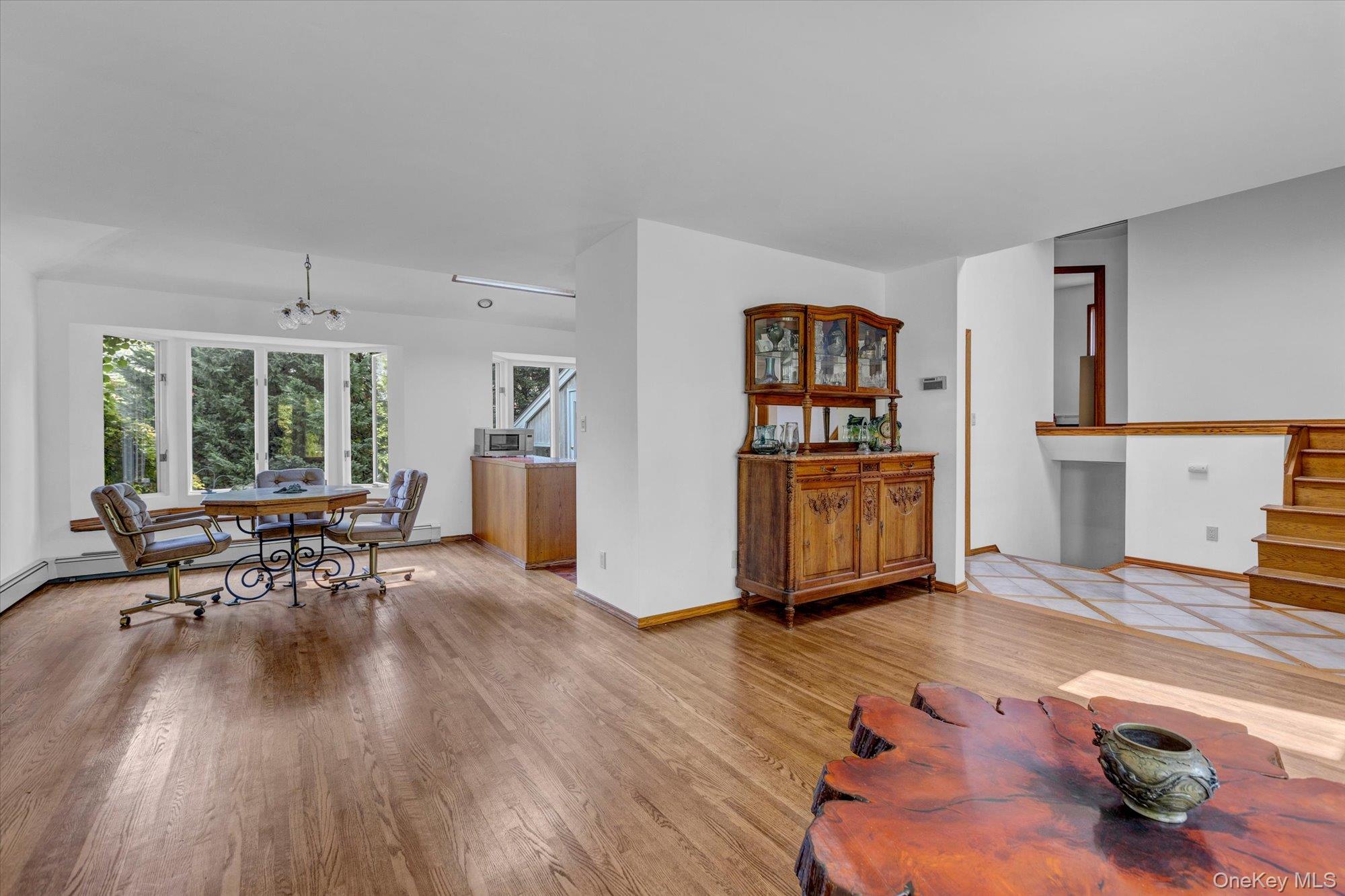 19 Clearland Road Syosset, NY 11791 - Photo 7 of 22 Living room with light wood-style flooring and a chandelier