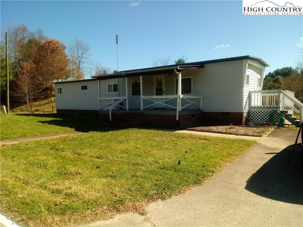 2449 Old Barrett Road Ennice, NC 28623 - Photo 1 of 12 a front view of a house with a yard