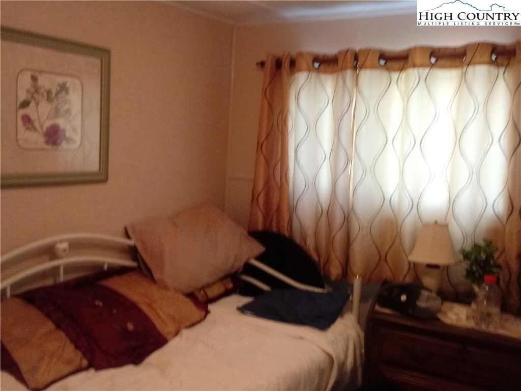 2449 Old Barrett Road Ennice, NC 28623 - Photo 4 of 12 a bedroom with a bed and furniture