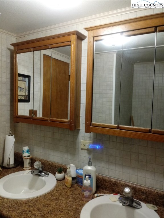 2449 Old Barrett Road Ennice, NC 28623 - Photo 9 of 12 a bathroom with a sink and a mirror