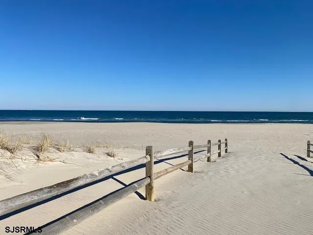 a view of a swimming pool with outdoor seating and lake view