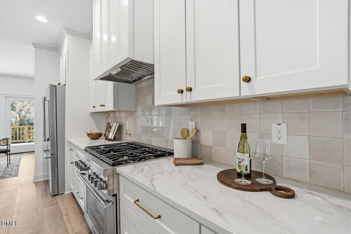 203 Baggett Avenue Raleigh, NC 27604 - Photo 11 of 45 a kitchen with a stove and cabinets