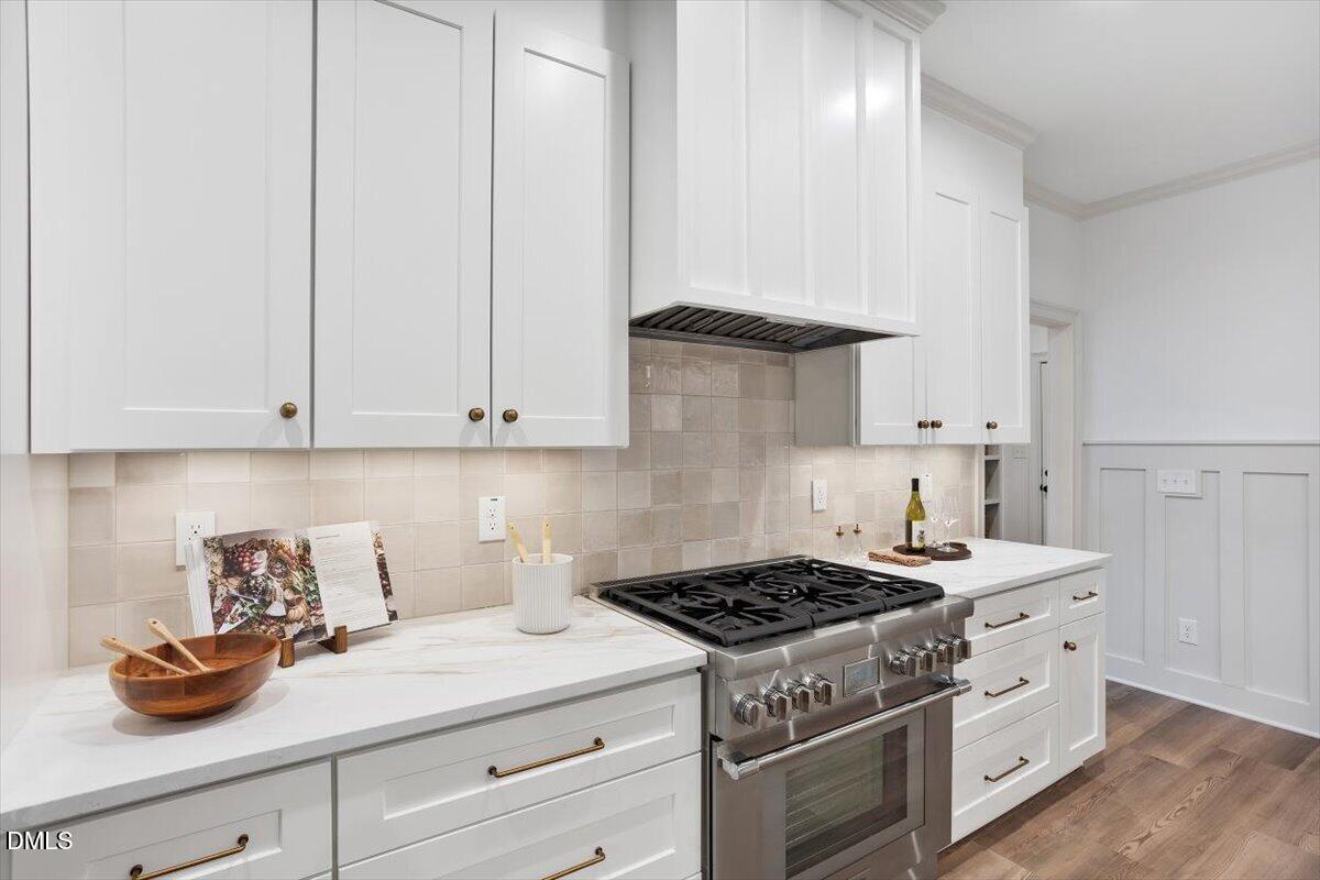 203 Baggett Avenue Raleigh, NC 27604 - Photo 15 of 51 a kitchen with granite countertop white cabinets and white stove