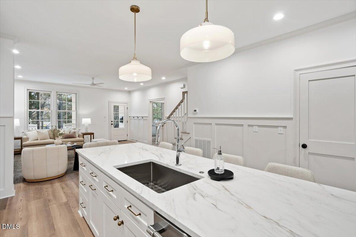 203 Baggett Avenue Raleigh, NC 27604 - Photo 17 of 52 a kitchen with a sink and a stove with wooden floor