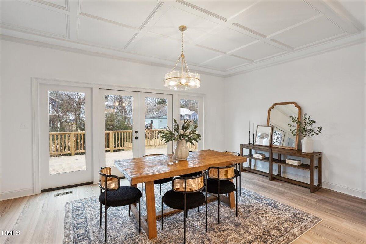 203 Baggett Avenue Raleigh, NC 27604 - Photo 20 of 51 a dining room with furniture a chandelier and wooden floor