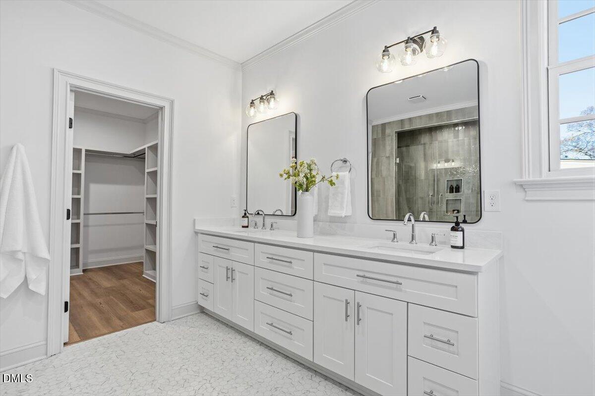 203 Baggett Avenue Raleigh, NC 27604 - Photo 24 of 51 a bathroom with a double vanity sink and mirror