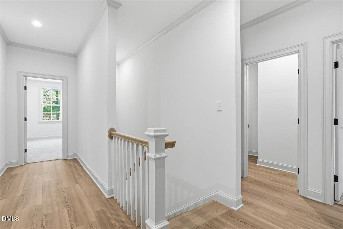 203 Baggett Avenue Raleigh, NC 27604 - Photo 25 of 45 a view of a hallway with wooden floor and a bathroom