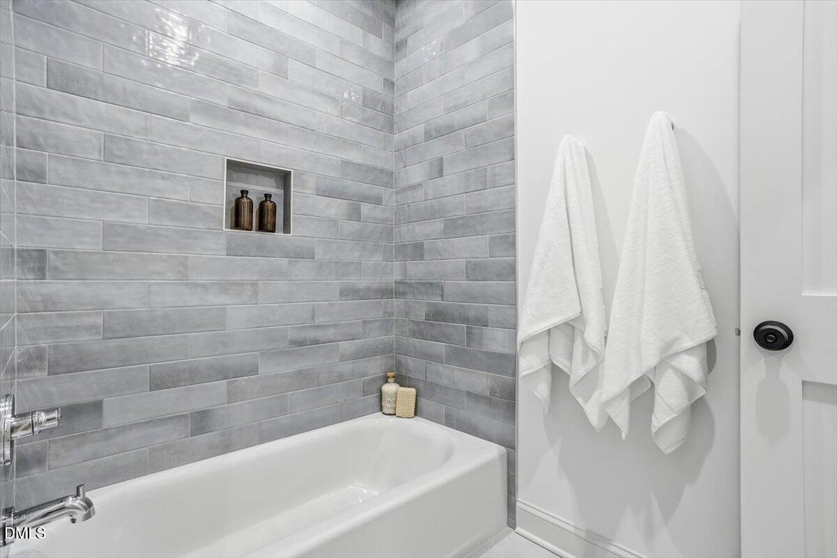 203 Baggett Avenue Raleigh, NC 27604 - Photo 29 of 45 a bathroom with a bathtub and shower
