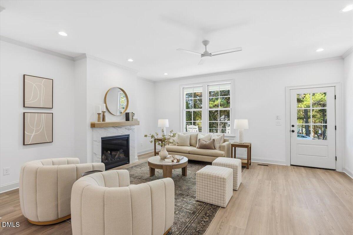 203 Baggett Avenue Raleigh, NC 27604 - Photo 6 of 45 a living room with furniture and a fireplace