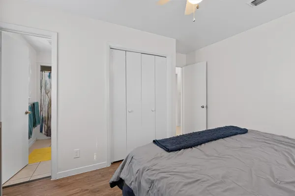a bedroom with a bed and a window