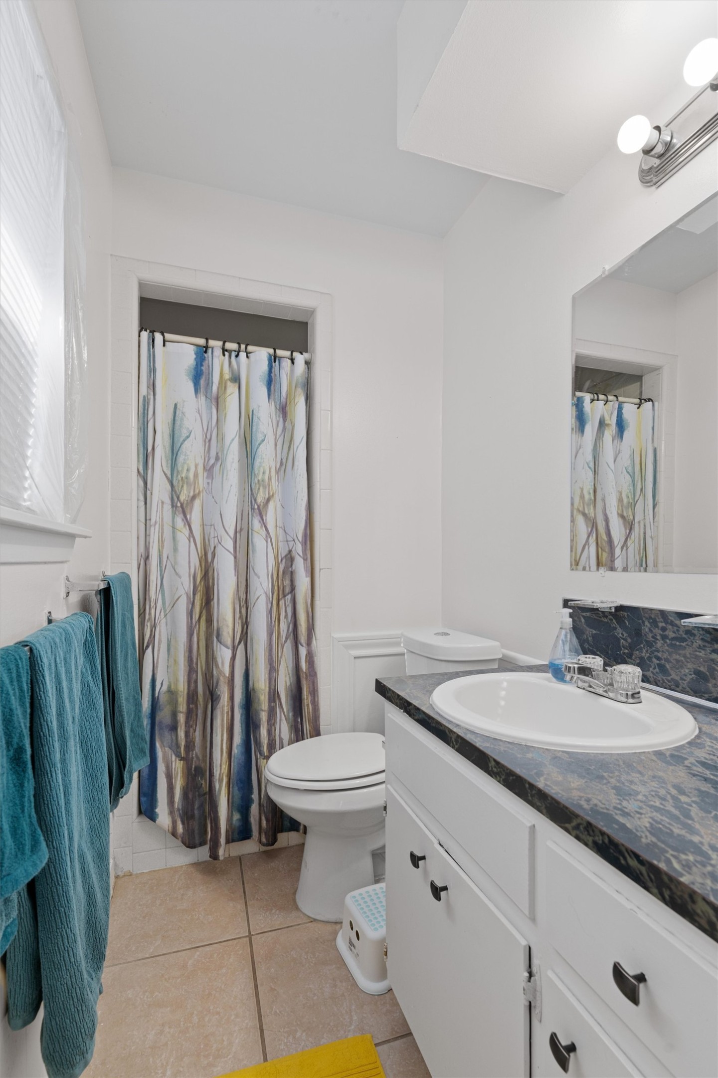 8204 Easter Cove Austin, TX 78757 - Photo 14 of 22 a bathroom with a granite countertop sink a toilet and a mirror