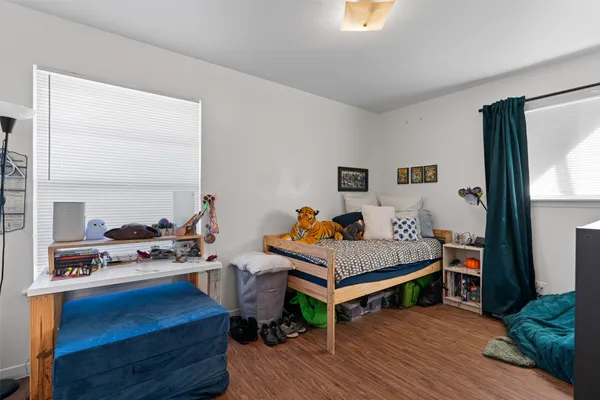 a bedroom with furniture and a wooden floor