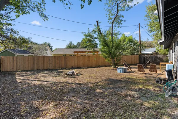 a backyard of a house with table and chairs