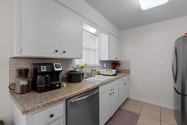 a kitchen with stainless steel appliances granite countertop a sink and cabinets