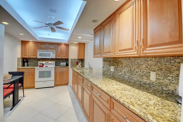 a kitchen with a sink cabinets and window