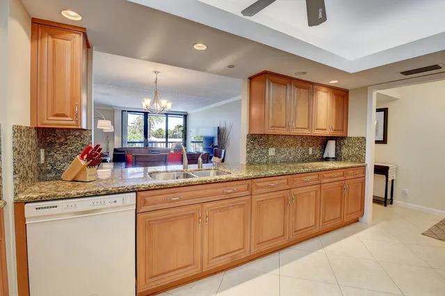 a bedroom with a bed a lamp and a large window