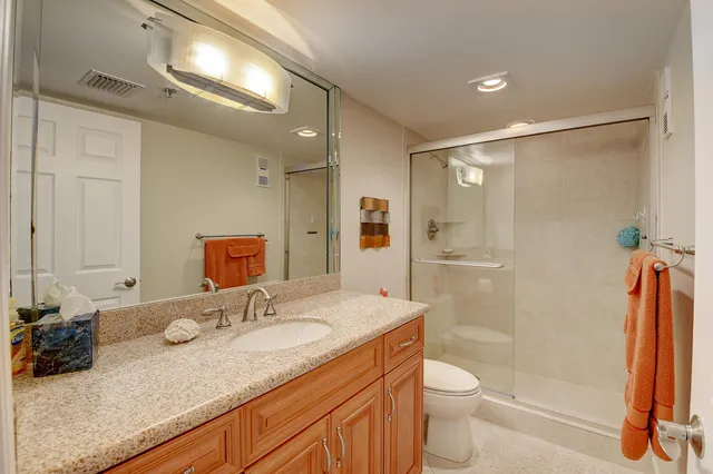 a bedroom with a bed and large windows