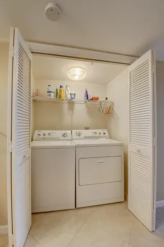 a view of a balcony with two chairs and a table