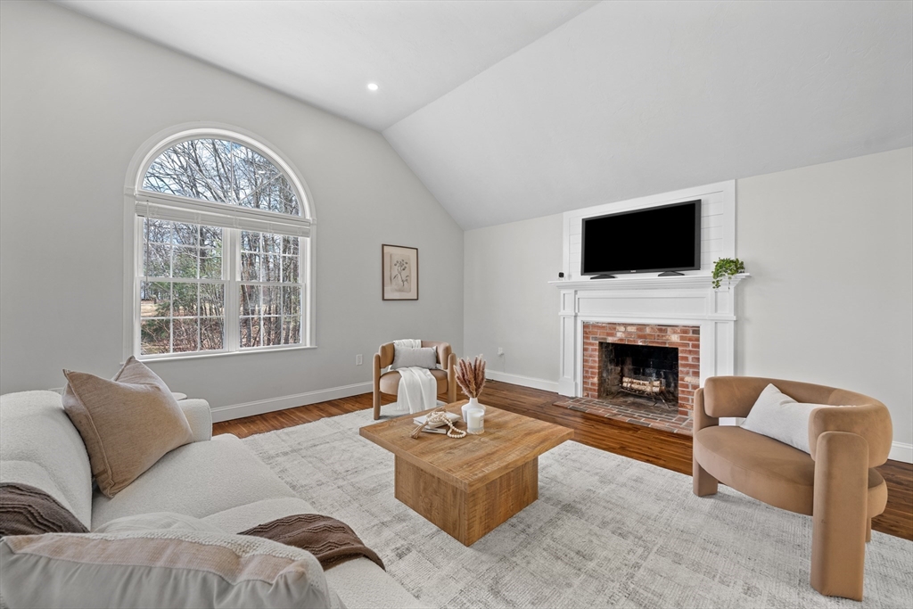 8 Virginia Avenue Sutton, MA 01590 - Photo 15 of 38 a living room with furniture a fireplace and a flat screen tv