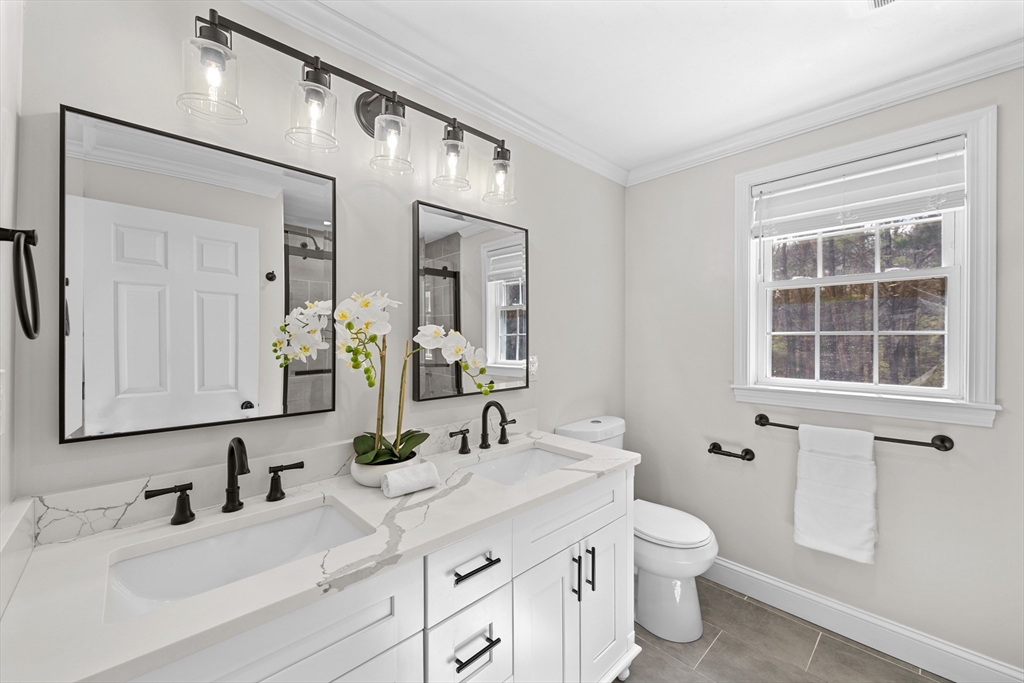 8 Virginia Avenue Sutton, MA 01590 - Photo 18 of 38 a bathroom with a double vanity sink toilet and mirror
