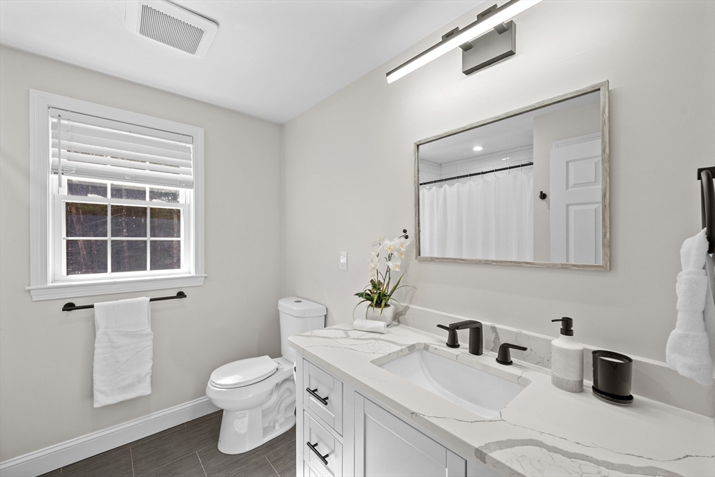 8 Virginia Avenue Sutton, MA 01590 - Photo 24 of 38 a bathroom with a sink vanity granite toilet and a mirror