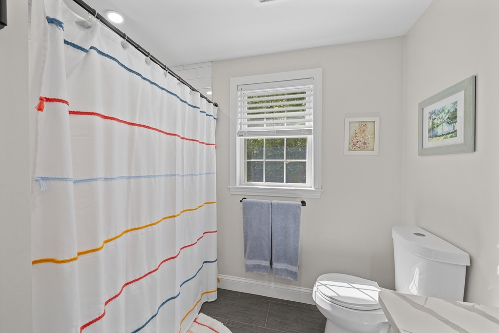 8 Virginia Avenue Sutton, MA 01590 - Photo 25 of 38 a bathroom with a sink a toilet a window and shower