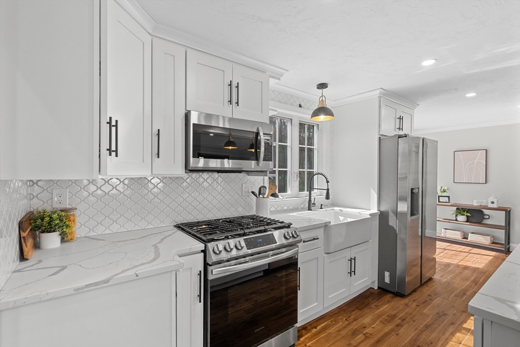 8 Virginia Avenue Sutton, MA 01590 - Photo 10 of 38 a kitchen with stainless steel appliances a stove microwave and sink
