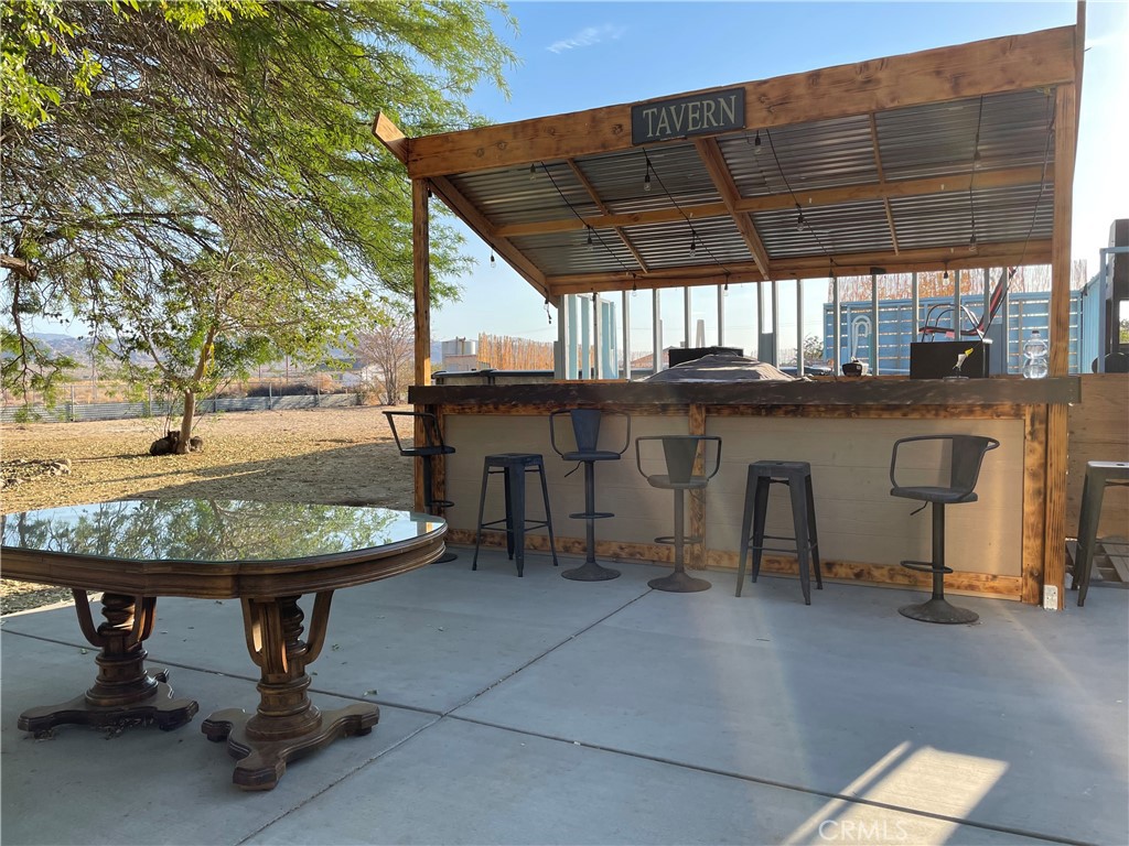 65585 4th Street South Joshua Tree, CA 92252 - Photo 20 of 27 a view of a chairs and table in the patio