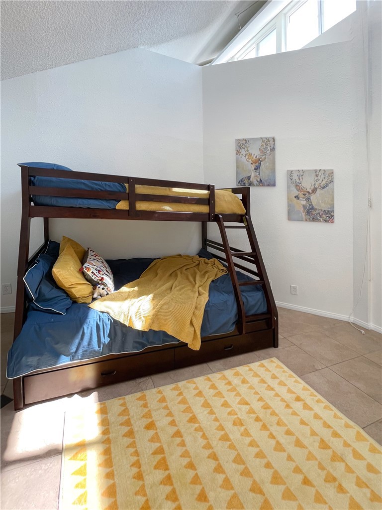 65585 4th Street South Joshua Tree, CA 92252 - Photo 22 of 27 a room with a bed and painting on the wall