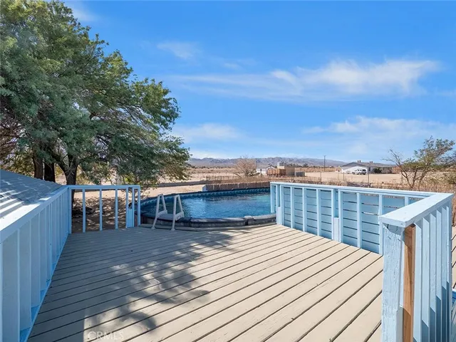 a view of a house with a wooden deck