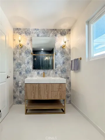 a bathroom with a sink a mirror and a toilet