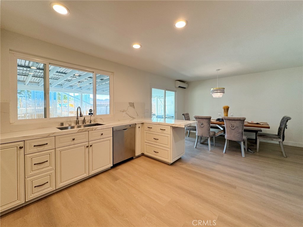 65585 4th Street South Joshua Tree, CA 92252 - Photo 8 of 27 a large white kitchen with white cabinets and wooden floor