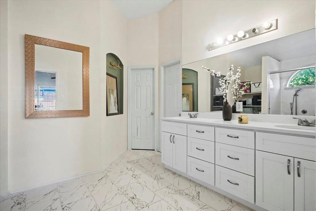 1412 Cheyenne Road Wylie, TX 75098 - Photo 21 of 24 Bathroom with double vanity, light marble finish flooring, and a shower stall