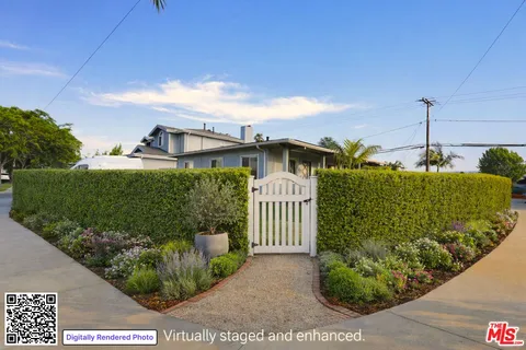 a view of a house with a small yard and plants