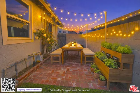 a backyard of a house with table and chairs