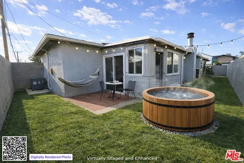 a backyard of a house with table and chairs