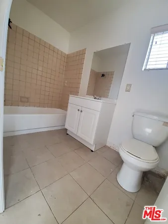 a bathroom with a toilet and a bathtub