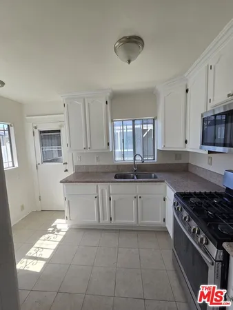 a kitchen with stainless steel appliances granite countertop a sink and cabinets
