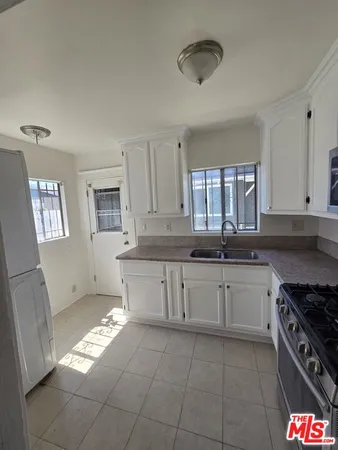 a kitchen with a stove a sink and a refrigerator