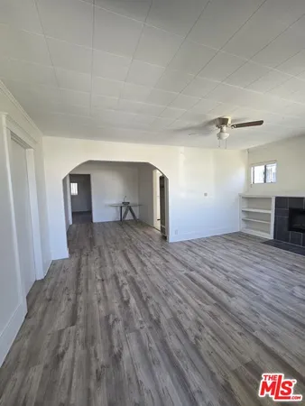 a view of a room with wooden floor