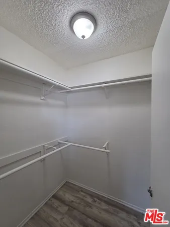 a room with linen closet and wooden floor