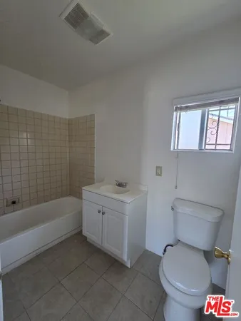 a bathroom with a sink a toilet and bathtub