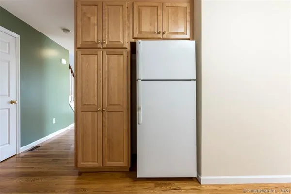 a view of storage and utility room with wooden floor
