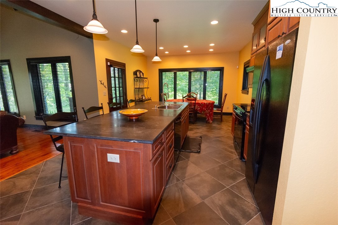 572 Stonegate Lane Creston, NC 28615 - Photo 12 of 48 a kitchen with a sink and large windows